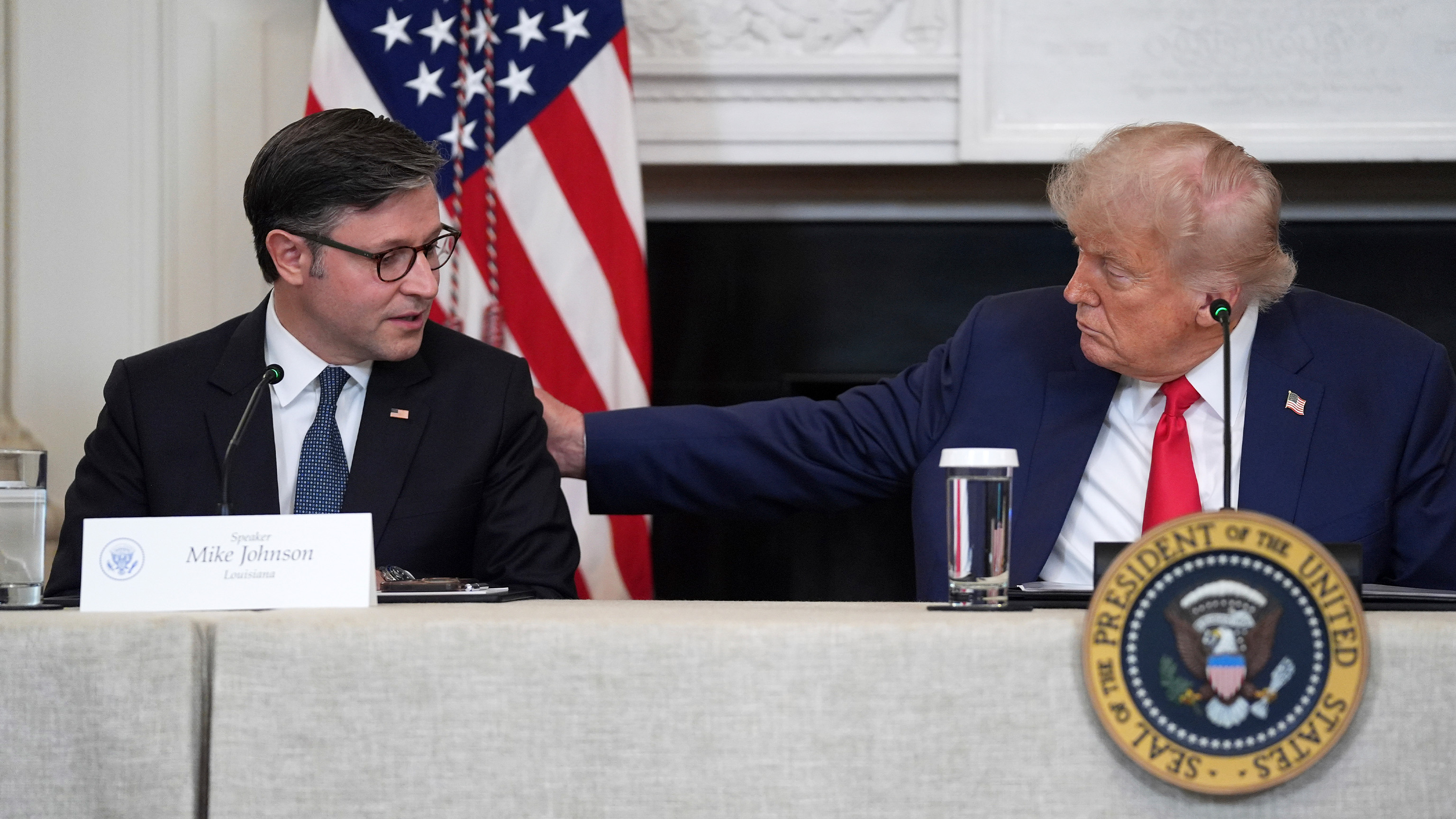 President Donald Trump listens as House Speaker Mike Johnson, R-La., speaks during an "Invest in America" roundtable with business leaders at the White House, Monday, June 9, 2025, in Washington.