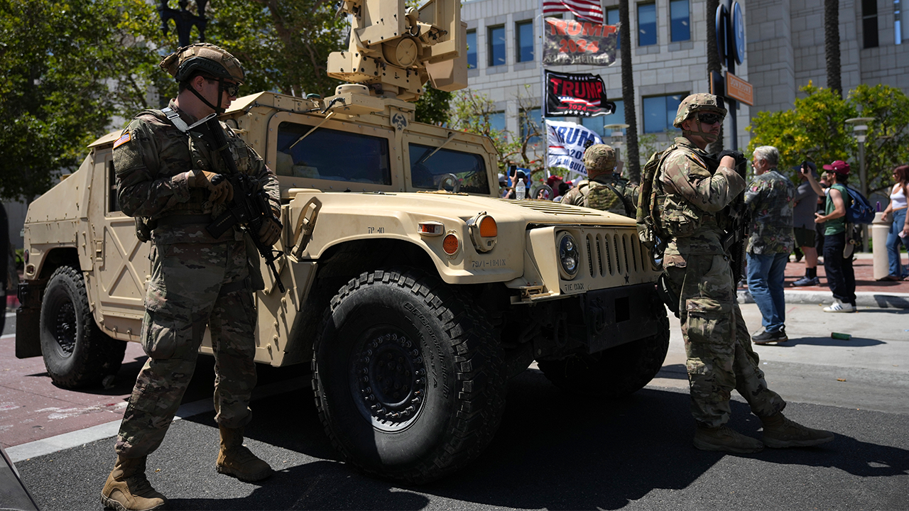 California National Guard stand guard along a street near protesters and Trump supporters in Santa Ana, Calif. on Tuesday, June 10, 2025.